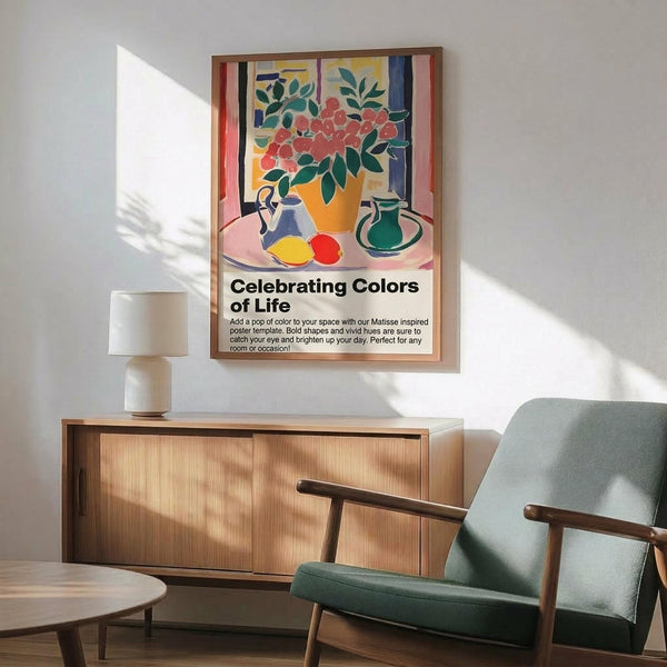 May include: Framed poster with colorful still life artwork featuring flowers in yellow vase, fruits, and pottery in Matisse-inspired style with bold reds, greens, and blues. Displayed above wooden sideboard with white ceramic lamp in modern living room with sage green upholstered chair and round coffee table. Bright natural lighting creates geometric shadows on white wall.