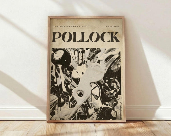 May include: Framed vintage-style poster featuring abstract black and white artwork with dynamic paint splatters, drips, and gestural marks. The cream-colored poster displays "POLLOCK" in bold letters with "CHAOS AND CREATIVITY 1912-1956" above. Set in light wood frame against white wall on wooden floor with natural lighting creating soft shadows.