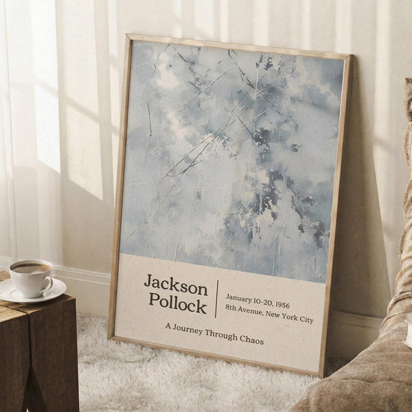 May include: Abstract expressionist artwork in muted blues and grays with gestural brushstrokes and splatters, displayed in a thin wooden frame. The poster features exhibition-style text below the artwork. Scene shows the framed print leaning against a white wall on a textured cream rug, with a coffee cup on a wooden side table and soft natural lighting creating geometric shadows.