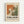 May include: Framed abstract art exhibition poster featuring Jackson Pollock-style paint splatters in orange, green, and white with bold black text reading "POLLOCK" and "EMBRACE THE CHAOTIC REALM OF CREATIVITY" with exhibition dates. Light wood frame with cream matting displayed on white wall.