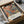 A framed poster titled "Jackson Pollock: A Journey Through Chaos" is displayed in a cardboard box, with a white tissue paper wrapping around it.