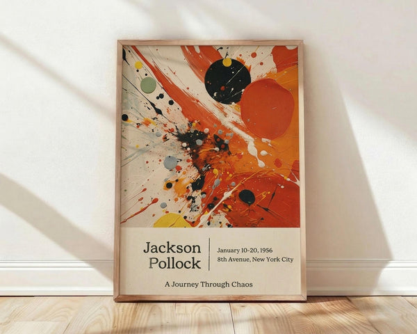 May include: Framed abstract art poster featuring Jackson Pollock's signature paint splatter style with vibrant orange, black, and cream colors. Dynamic brushstrokes and paint splatters create energetic movement across the canvas. Exhibition details showing January 10-20, 1956 at 8th Avenue, New York City with subtitle "A Journey Through Chaos." Natural wood frame displayed against white wall on light wooden floor with soft shadows.