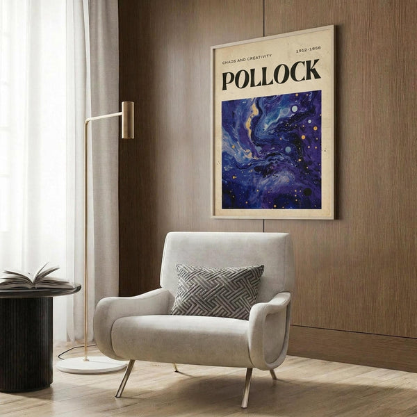 May include: Abstract swirling blue and purple poster with cosmic design featuring scattered dots and flowing paint-like patterns, displayed in light wood frame on wood paneled wall above beige upholstered armchair with geometric patterned pillow, alongside brass floor lamp and dark round side table with open book.