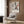 a modern living room with a white armchair, a floor lamp, and a framed abstract art print hanging on the wall.