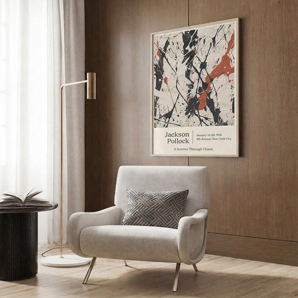 a modern living room with a white armchair, a floor lamp, and a framed abstract art print hanging on the wall.