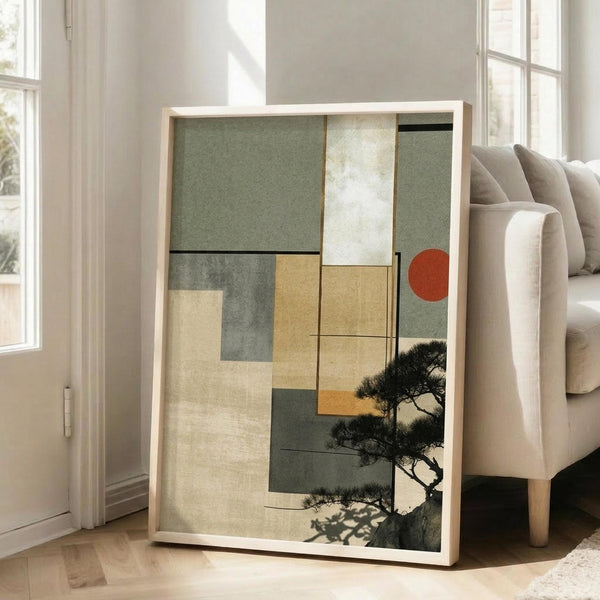 May include: Framed abstract artwork leaning against white wall next to beige upholstered chair in bright living room. Print features geometric blocks in sage green, cream, golden yellow and gray tones with silhouetted pine tree branches and coral red circle accent. Natural wood frame, warm sunlight streaming through windows onto hardwood floors.
