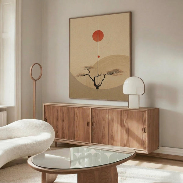 May include: Minimalist Japanese-inspired artwork hanging above a wooden credenza in a modern living room. The poster features a beige background with a red sun, curved line, small tree silhouette, and geometric shapes in earth tones. White mushroom table lamp and wooden floor lamp flank the credenza. White curved chair and glass-top coffee table complete the serene, mid-century modern space with warm wood tones.