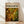 May include: Framed abstract expressionist artwork with swirling patterns of golden yellow, olive green, and brown paint with scattered white circular forms, displayed in light wood frame against white wall on wooden floor with natural sunlight casting diagonal shadows across the scene.