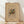 May include: Framed abstract art print with geometric shapes and bold colors including yellow, blue, red, and green on beige background, displayed in natural wood frame against white wall on light wooden floor with soft natural lighting creating diagonal shadows.