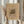 May include: Person in cream ruffled sleeves holding framed abstract art print with colorful geometric shapes, lines and forms in yellow, blue, red and green on beige background, alongside dried pampas grass stems against soft neutral curtained window setting