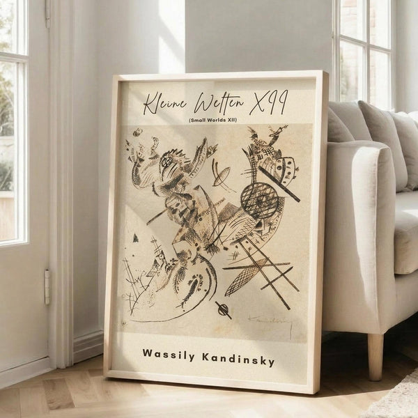 May include: Abstract art print by Wassily Kandinsky in light wood frame, leaning against white wall next to beige sofa. The artwork features dynamic black ink drawings with geometric shapes, organic forms, and intersecting lines on cream background. Bright natural light streams through tall windows onto hardwood floors in minimalist living room setting.