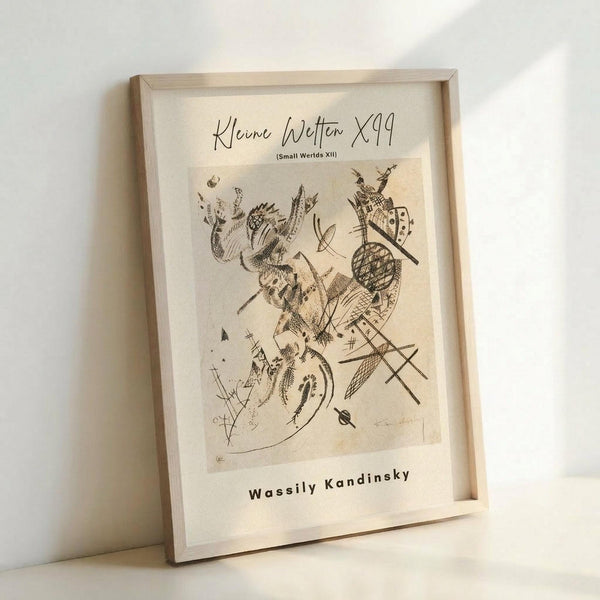 May include: A framed abstract art print displayed on a white surface against a white wall. The artwork features black line drawings with organic, flowing forms and geometric shapes on cream-colored paper. The print is housed in a light natural wood frame and shows text at the top and bottom. The composition includes curved lines, crosshatched patterns, and various abstract elements creating a dynamic, modernist design.