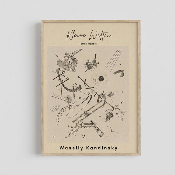Framed abstract art print featuring black line drawings on cream background. Geometric and organic shapes include crosshatched forms, dots, curved lines, and angular elements in Kandinsky's distinctive style. Thin wooden frame hangs on white wall. Drawing shows dynamic composition with intersecting lines, circles, and abstract figures scattered across the composition.