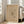May include: Framed abstract art print with beige background featuring black linear geometric designs and scattered dot patterns, displayed in light wooden frame leaning against white wall next to beige upholstered sofa in bright, sunlit room with white window frames and wooden flooring.