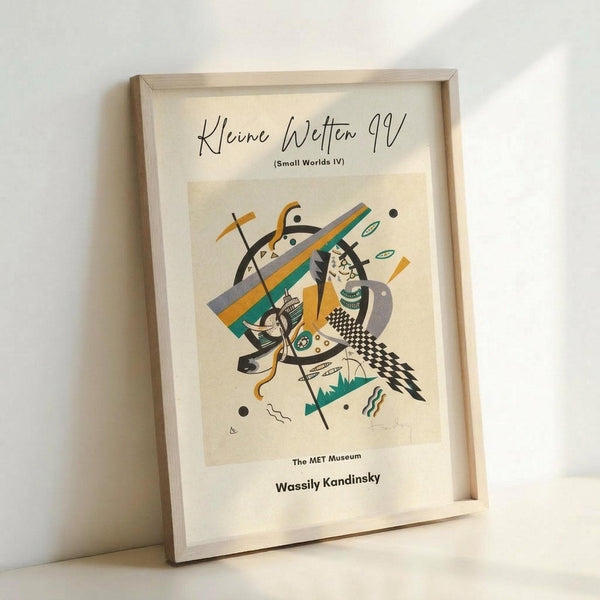 May include: Framed abstract art print leaning against white wall in light wooden frame. Artwork features geometric shapes, curved lines, and angular forms in colors including orange, teal, black, gray, and cream with checkered patterns and organic elements. Museum-style poster with German title and artist attribution at bottom.