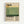 Framed poster with minimalist design featuring horizontal color blocks in cream, yellow, sage green, and dark green. Bold black typography displays "Mark Rothko" at top and bottom, with birth and death dates "09.1903" and "02.1970" vertically aligned on right side. Small paragraph of descriptive text appears in bottom left corner. Poster has light wood frame and hangs on white wall.