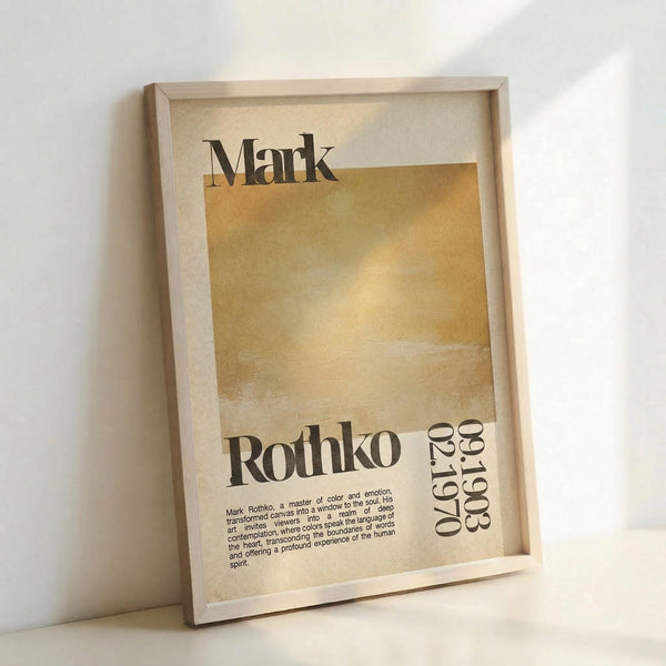 May include: Framed art print leaning against white wall featuring abstract golden yellow and cream colored blocks with "Mark Rothko" text and "02.1970" dates. Print has vintage-inspired typography and descriptive text about the artist. Light wood frame with beige matting, photographed in natural lighting showing shadows on wall.