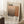 May include: Framed poster leaning against white wall featuring abstract earth-toned rectangular color blocks in cream, peach, and brown gradients with "Mark Rothko" text and biographical information below. Scene shows coffee cup on wooden side table, white furry rug, and beige fabric chair in soft natural lighting.
