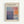 May include: Framed exhibition poster for Mark Rothko featuring abstract color field artwork in blues, purples, oranges and whites. The poster shows gallery information for Rothko Art Gallery in New York City with exhibition dates April 15 - July 30, 2023. Light wood frame against white wall background in modern interior setting.
