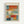 May include: Framed abstract art print in light wood frame hanging on white wall. Artwork features soft rectangular color blocks in muted blues, oranges, reds, yellows and whites with painterly blended edges. French text above reads "L'abstraction émotionnelle à la manière de" followed by "MARK ROTHKO" in large letters. Contemporary minimalist room setting.