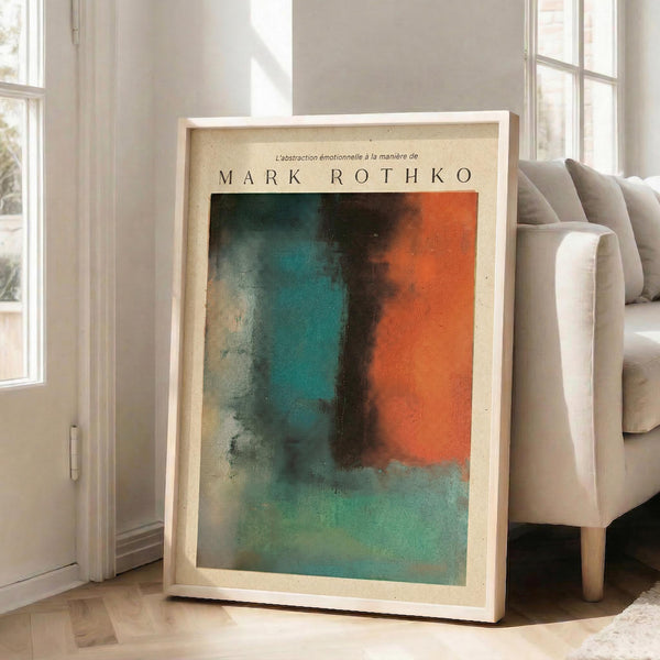 May include: Large framed abstract art print leaning against white wall in bright living room with beige sofa. Artwork features bold color blocks in turquoise, orange, and dark tones with soft blended edges in Rothko's signature style. Light wood frame with cream matting. Sunlight streams through tall windows onto hardwood floors.