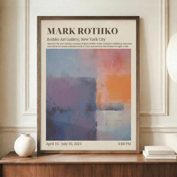 May include: Framed exhibition poster featuring Mark Rothko's abstract artwork with soft blocks of blue, purple, orange, and cream colors. The poster displays gallery information and exhibition dates, shown in a brown wooden frame on a wooden credenza alongside a white ceramic vase and stacked books in a bright interior setting with white paneled walls.