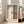 May include: Abstract art poster with soft geometric blocks in muted blue, cream, orange and brown tones in light wooden frame, leaning against white wall next to beige upholstered sofa in bright room with large windows and natural lighting on light floors.