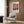 a modern living room with a white armchair, a floor lamp, and a framed poster on the wall.