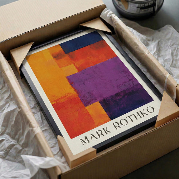 A framed abstract painting titled "Mark Rothko" is displayed in a cardboard box, which is wrapped in plastic.
