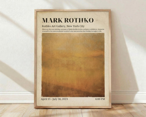 May include: Framed exhibition poster featuring Mark Rothko's signature abstract color field painting in warm golden and amber tones. The cream-colored poster displays gallery information and exhibition dates. Wooden frame rests against white wall on light wood flooring with natural shadows from window light creating diagonal patterns across the scene.