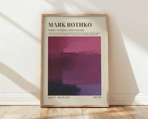 May include: Framed exhibition poster featuring Mark Rothko's abstract color field painting in deep burgundy, magenta, and purple tones. The cream-colored poster displays gallery information and exhibition dates from April to July 2023. Natural wood frame sits against white baseboard on light wooden floor with soft natural lighting and fabric shadows visible in background.