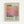 May include: Framed poster mounted on white wall featuring Mark Rothko's name in large black text above soft gradient artwork in orange, pink, and purple hues. Below the artwork is "Rothko" in black text with dates "03.25.1903 - 02.25.1970" and descriptive text about the artist's mastery of color and emotion. Light wood frame surrounds cream-colored background.
