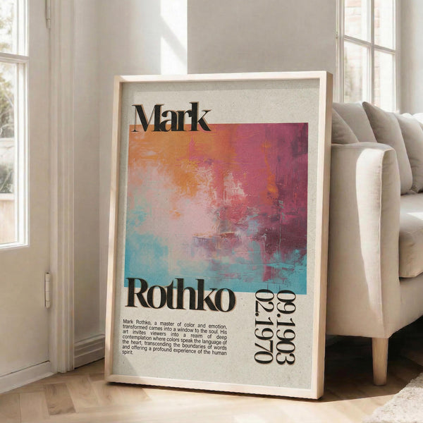 May include: Framed poster with abstract colorful artwork in vibrant pink, orange, blue and white brushstrokes, featuring "Mark Rothko" text and descriptive paragraph below, displayed against white wall next to beige sofa with natural lighting from windows