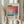 May include: Hands holding a framed abstract art print in warm light near a window. The poster features colorful brushstrokes in orange, pink, blue and turquoise tones with black typography reading "Mark Rothko" and dates "09.17.30 - 08.08.68". Small descriptive text appears below the artwork. Dried pampas grass visible on the left side, cream curtains in soft window lighting.