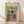 May include: Framed abstract art poster with geometric squares in muted teal, rust orange, yellow and purple tones, leaning against white wall on light wooden floor with soft natural lighting and shadows