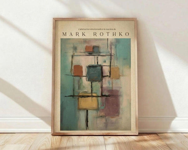 May include: Framed abstract art poster with geometric squares in muted teal, rust orange, yellow and purple tones, leaning against white wall on light wooden floor with soft natural lighting and shadows
