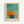 May include: Framed abstract art print in light wood frame hanging on white wall. Artwork features turquoise blue background with orange and yellow geometric shapes suggesting a sailboat, with muted teal and beige lower section. French text at bottom reads "L'abstraction émotionnelle à la manière de Mark Rothko" with artist name. Soft color blocking style with painterly texture and horizontal composition.