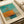 The image is a framed abstract painting with a blue and orange color scheme.