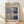 May include: Framed exhibition poster featuring Mark Rothko's abstract color field artwork with soft blues, grays, purples and cream rectangular blocks. Gallery information and exhibition dates displayed in black text on cream background. Natural wood frame leaning against white wall on light wooden floor with soft window light shadows.