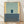 May include: Framed minimalist abstract art print leaning against white wall on light wood floor. Features geometric composition with sage green upper section, yellow vertical strips on sides, dark navy rectangle in center, and charcoal gray bottom portion with white text reading "MARK ROTHKO". Natural wood frame, soft natural lighting creates gentle shadows.