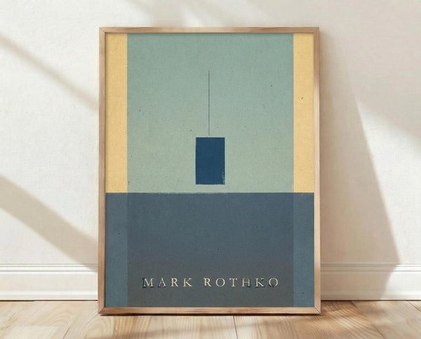 May include: Framed minimalist abstract art print leaning against white wall on light wood floor. Features geometric composition with sage green upper section, yellow vertical strips on sides, dark navy rectangle in center, and charcoal gray bottom portion with white text reading "MARK ROTHKO". Natural wood frame, soft natural lighting creates gentle shadows.