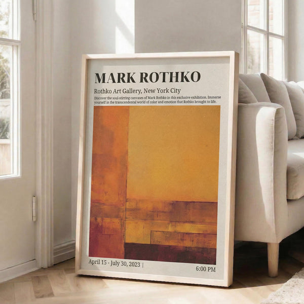May include: Framed exhibition poster for Mark Rothko leaning against white wall next to beige sofa. Features abstract orange and rust colored rectangular blocks in warm gradient tones. Gallery information and exhibition dates displayed at top. Natural sunlight streams through windows onto light wooden floors creating soft shadows.