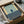 a framed artwork, possibly a poster or painting, placed in a cardboard box.