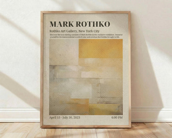 May include: Framed exhibition poster for Mark Rothko displayed on light wooden floor against white wall with soft natural lighting. Poster features abstract geometric composition in muted yellows, beiges and grays with exhibition text at top including gallery name and dates. Natural wood frame surrounds cream-colored print with minimalist modern aesthetic.