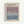 May include: Framed exhibition poster with cream background featuring Mark Rothko's name in bold black letters at top. Below shows gallery information and descriptive text about soul-stirring canvases. Central image displays gradient artwork transitioning from dusty purple at top to blue-gray at bottom with subtle texture. Exhibition dates April 15 - July 30, 2023 and 6:00 PM shown at bottom. Light wood frame against white wall.
