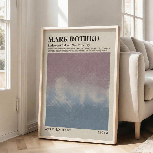 May include: Framed art poster leaning against white wall next to beige sofa in bright living room. Poster features gradient artwork transitioning from purple at top to blue at bottom, with exhibition text and dates. Light wood frame, natural lighting from windows, hardwood floors visible.