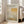 May include: Framed exhibition poster featuring Mark Rothko's abstract color field artwork in warm yellows, oranges, and neutral tones, displayed in a bright living room with white walls, large windows, and beige upholstered chair. The poster shows geometric rectangular blocks of color with gallery information and dates printed at top and bottom.