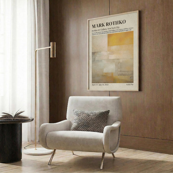 a modern living room with a white armchair, a floor lamp, and a framed poster on the wall.