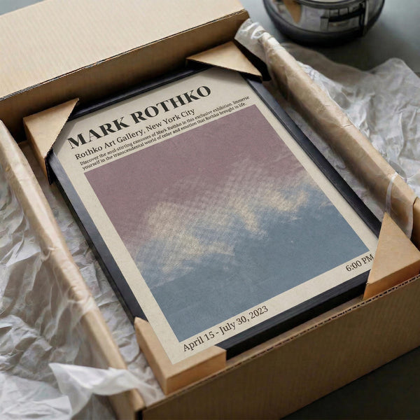 a framed poster or flyer for an art exhibition, with a blue and white color scheme, placed in a cardboard box.