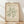May include: Framed art print leaning against white wall on light wooden floor. Cream-colored poster features green coral-like botanical cutout design in Matisse paper cut style. Text reads "MATISSE PAPIERS DÉCOUPÉS" at top and "BERGGRUEN & CIE" with Paris gallery details below. Natural wood frame with warm lighting and soft fabric shadows visible in background.